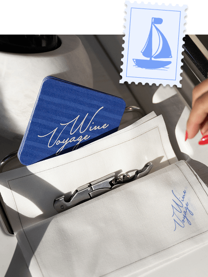 A Wine Voyage boarding card and sailboat stamp